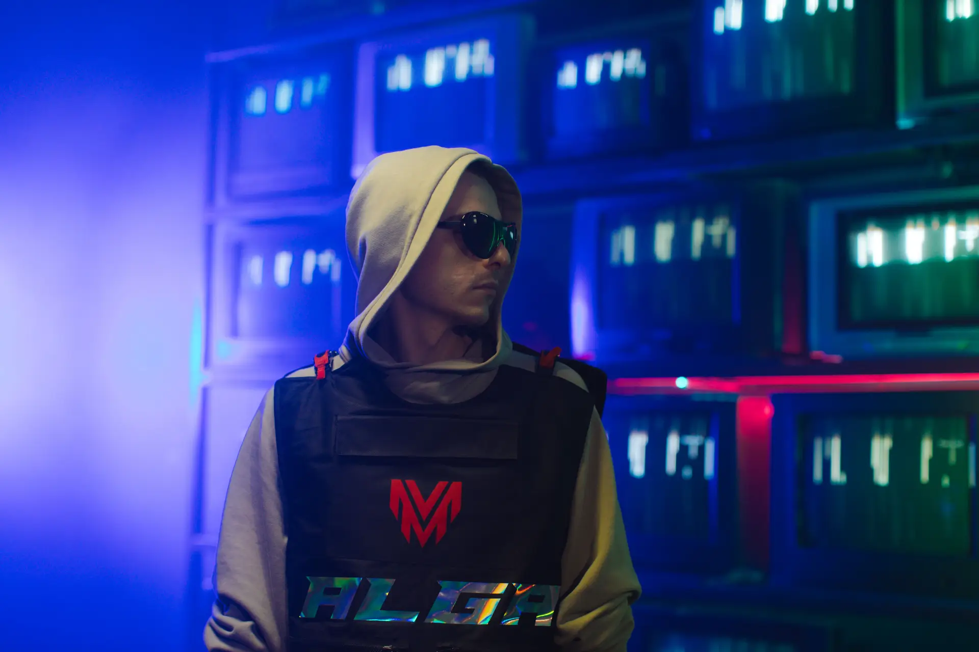 Streamer mit Sonnenbrille vor Bildschirmen